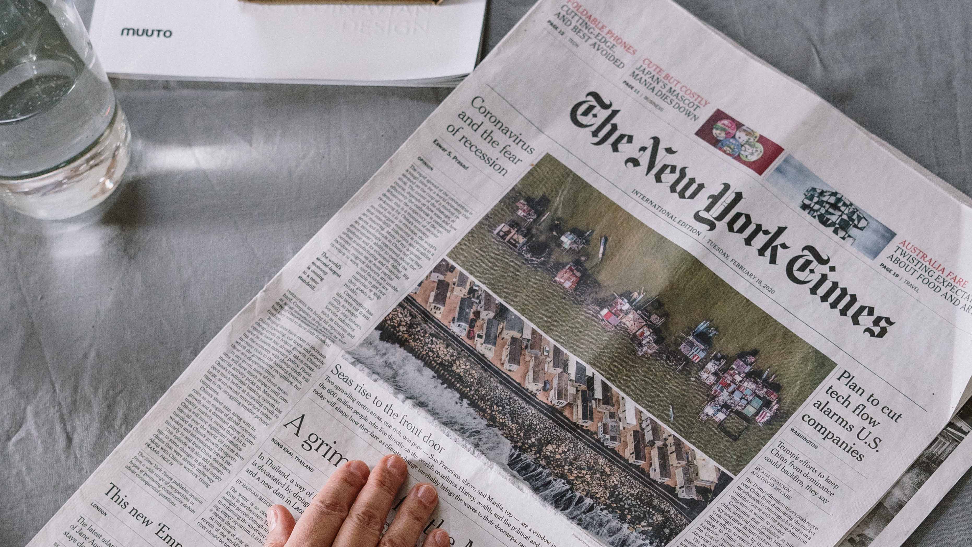 person-reading-newspaper-on-table-4057766