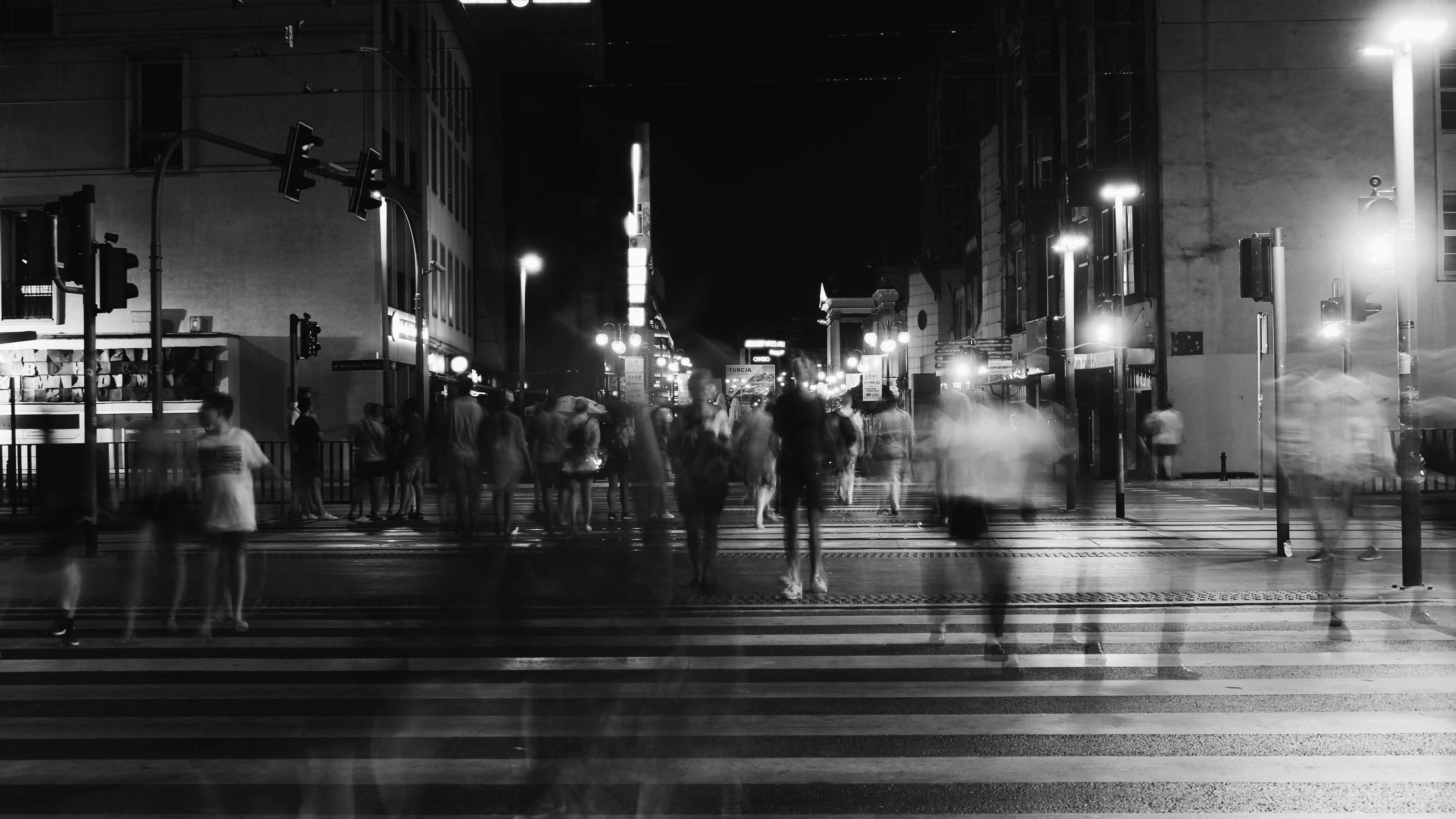 group-of-people-crossing-pedestrian-lane-in-greyscale-1309687